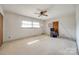 Spacious bedroom with neutral carpet, ceiling fan, and a window offering natural light at 4500 Town And Country Dr, Charlotte, NC 28226