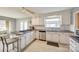 Well-lit kitchen featuring white cabinets and stainless steel dishwasher at 4500 Town And Country Dr # 18, Charlotte, NC 28226