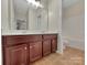 A bathroom featuring a double vanity and a toilet and tub combo in its own alcove at 5002 Fine Robe Dr, Indian Trail, NC 28079