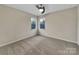A cozy carpeted bedroom with a ceiling fan and two windows, offering ample light at 5002 Fine Robe Dr, Indian Trail, NC 28079