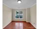 Bright bedroom with hardwood floors, large windows offering natural light, and neutral walls for versatile decor options at 5002 Fine Robe Dr, Indian Trail, NC 28079