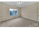 Bright carpeted bedroom with a large window offering a pleasant outdoor view at 5002 Fine Robe Dr, Indian Trail, NC 28079