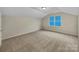 Empty bedroom featuring neutral walls, carpet, and a window at 5002 Fine Robe Dr, Indian Trail, NC 28079