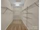 Walk-in closet featuring wire shelving, a neutral paint color, and carpeted floors at 5002 Fine Robe Dr, Indian Trail, NC 28079