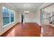 Elegant dining room with wainscoting, hardwood floors, chandelier, and large windows offering backyard view at 5002 Fine Robe Dr, Indian Trail, NC 28079