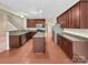 Modern kitchen featuring dark wood cabinets, granite countertops, stainless steel appliances, and a functional island at 5002 Fine Robe Dr, Indian Trail, NC 28079