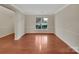 Spacious living room featuring hardwood floors, ample natural light from a large window, and neutral paint at 5002 Fine Robe Dr, Indian Trail, NC 28079