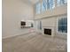 Spacious living room with tall windows and a fireplace at 5002 Fine Robe Dr, Indian Trail, NC 28079