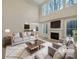 Bright, staged living room with fireplace and large windows letting in lots of natural light at 5002 Fine Robe Dr, Indian Trail, NC 28079