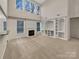 Bright and airy living room featuring a fireplace, built-in shelving, large windows, and plush carpeting at 5002 Fine Robe Dr, Indian Trail, NC 28079