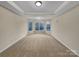 Large main bedroom with a tray ceiling, plush carpet, and many windows that provide natural light at 5002 Fine Robe Dr, Indian Trail, NC 28079