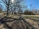 Large backyard featuring a picnic table and tall bare trees offering ample shade at 502 E Maine Ave, Bessemer City, NC 28016