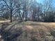 View of a large backyard featuring a picnic table and tall bare trees providing shade at 502 E Maine Ave, Bessemer City, NC 28016