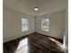 Bedroom with laminate flooring, white walls and trim, and natural light at 502 E Maine Ave, Bessemer City, NC 28016