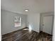 Bedroom featuring laminate flooring, white walls and trim, and a window at 502 E Maine Ave, Bessemer City, NC 28016