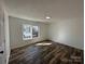 This bedroom has dark wood flooring and a window to let in natural light at 502 E Maine Ave, Bessemer City, NC 28016
