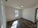 Bedroom featuring laminate flooring, white walls and trim, and a window at 502 E Maine Ave, Bessemer City, NC 28016