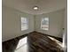 Bedroom with laminate flooring, white walls and trim, and natural light at 502 E Maine Ave, Bessemer City, NC 28016
