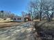 Charming single-story home with black shutters and a long driveway with trees on the right side of the house at 502 E Maine Ave, Bessemer City, NC 28016