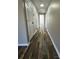 Hallway with wood-look flooring leading to multiple rooms, perfect for navigation at 502 E Maine Ave, Bessemer City, NC 28016