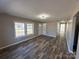 Open living room with natural light, wood-look flooring, and a welcoming atmosphere at 502 E Maine Ave, Bessemer City, NC 28016
