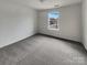 Bright bedroom featuring neutral carpet, white walls, and a window offering natural light at 6148 Durango Way, Denver, NC 28037