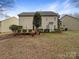 Backyard featuring a wood deck, a manicured lawn, mature trees, and a view of the home's exterior at 621 Ravenglass Dr, Fort Mill, SC 29715