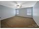 Bedroom with neutral carpet, window, and ceiling fan at 621 Ravenglass Dr, Fort Mill, SC 29715