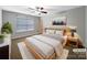 Stylishly staged bedroom featuring modern furniture, soft textures, and a serene color palette at 621 Ravenglass Dr, Fort Mill, SC 29715