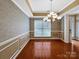 This dining room features hardwood floors, neutral colors, and decorative crown molding at 621 Ravenglass Dr, Fort Mill, SC 29715