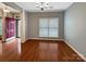 Bright dining room with hardwood floors, neutral walls, crown molding, and natural light from the window at 621 Ravenglass Dr, Fort Mill, SC 29715