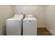 Laundry room featuring a white washer and dryer, with metal shelving above at 621 Ravenglass Dr, Fort Mill, SC 29715