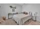 Bedroom with a white quilted comforter, minimalist decor and natural light at 6278 Ashton Park Dr, Denver, NC 28037