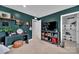 Bedroom with dark teal walls, a desk area, and a walk-in closet at 6278 Ashton Park Dr, Denver, NC 28037