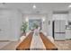 Elegant dining room with a large wooden table, stylish decor, and modern lighting at 6278 Ashton Park Dr, Denver, NC 28037