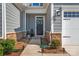 Charming front entrance with a decorative wreath, stone accents, and manicured landscaping at 6278 Ashton Park Dr, Denver, NC 28037