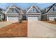 Exterior view of townhomes featuring two-car garages and gray siding at 6278 Ashton Park Dr, Denver, NC 28037