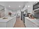 Bright, open kitchen featuring white cabinets, stainless steel appliances, and an island with sink at 6278 Ashton Park Dr, Denver, NC 28037