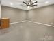 A clean, unfinished basement with concrete floors and a ceiling fan at 705 Old Cove Rd, Tega Cay, SC 29708