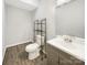 A modern bathroom with a toilet and sink, and wood-look flooring at 705 Old Cove Rd, Tega Cay, SC 29708