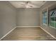 Neutral bedroom featuring stylish ceiling fan and plenty of natural light from two windows at 705 Old Cove Rd, Tega Cay, SC 29708