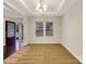 Bright dining room with a modern chandelier and large windows at 705 Old Cove Rd, Tega Cay, SC 29708