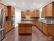 Stylish kitchen with stainless steel appliances, island, and modern backsplash at 705 Old Cove Rd, Tega Cay, SC 29708
