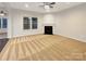 Bright living room with a cozy fireplace and large windows for natural light at 705 Old Cove Rd, Tega Cay, SC 29708