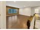 Open-concept living room with hardwood floors and natural light from large windows at 705 Old Cove Rd, Tega Cay, SC 29708