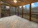 Enclosed back porch with wood flooring and windows offering outdoor views at 705 Old Cove Rd, Tega Cay, SC 29708