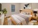 Stylishly staged bedroom with neutral tones, featuring a large window and contemporary artwork at 705 Old Cove Rd, Tega Cay, SC 29708