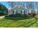 Charming home featuring a lush green lawn, tidy shrubbery, and pleasant light blue siding at 7328 Lancashire Dr, Mint Hill, NC 28227