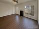 Bright living room features a fireplace, large windows, and hardwood floors at 8310 Shinkansen Dr, Charlotte, NC 28213