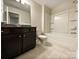 Bathroom featuring a vanity, toilet, and a tub/shower combination with built-in shelving at 8619 Harris Lake Ln, Charlotte, NC 28269